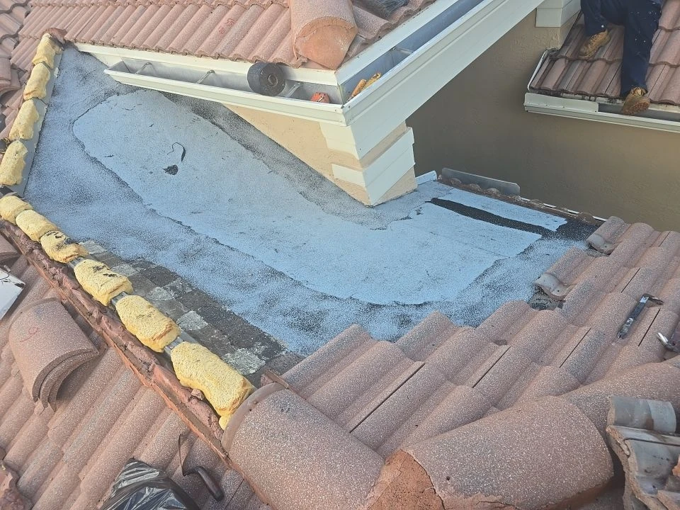 Haller Residence cricket repair, light granulated membrane at the roof-wall transition