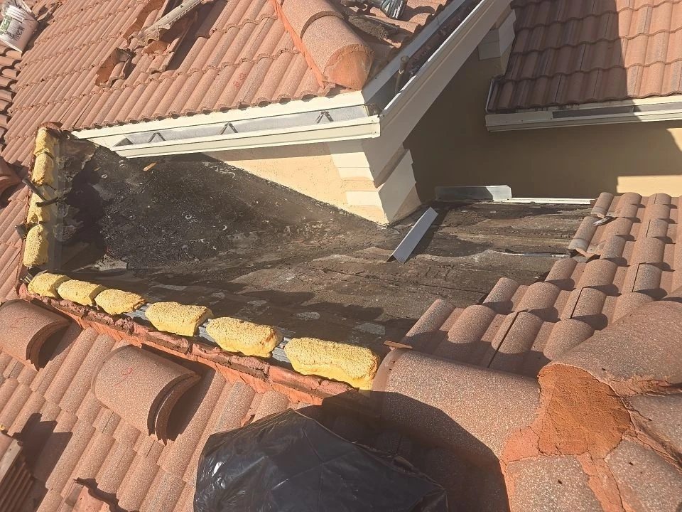 Exposed cricket area during a KLR tile-roof repair